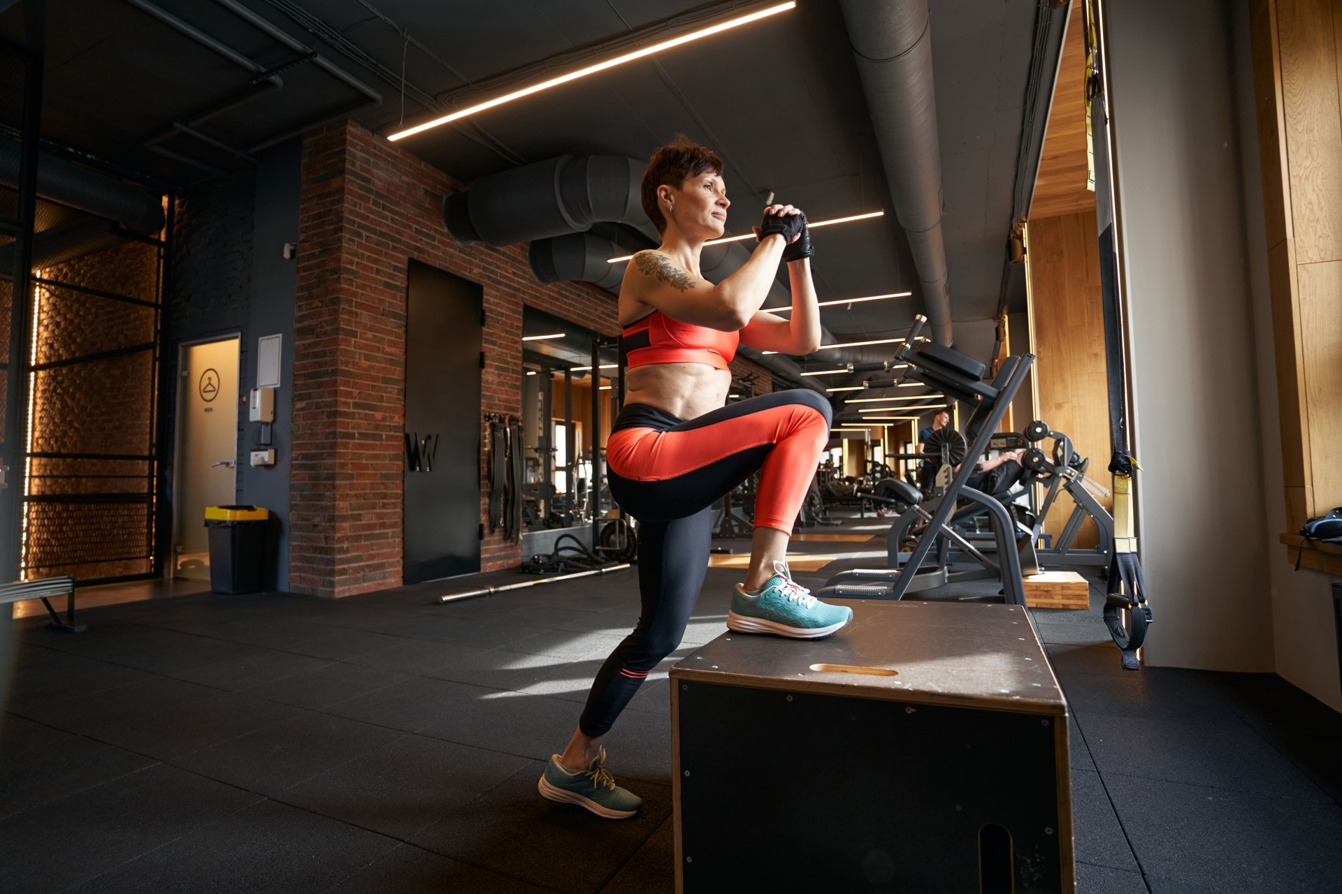 Sportswoman doing plyometric training in fitness club